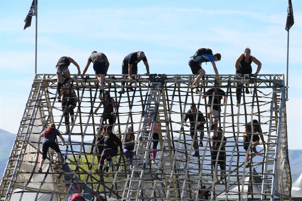 Obstacles coming our way. A group of men making way through a hurdle